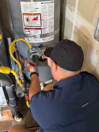 Mike the owner and master plumber is servicing a customers water heater in Concord, CA