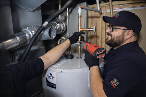 Professional installing 50-gallon commercial-grade gas water heater in Hillcrest neighborhood in Pleasant Hill