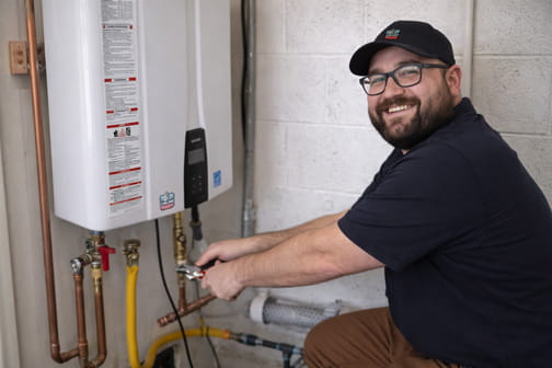 Water heater specialist servicing tankless system in Pleasant Hill residence