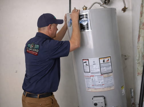 Professional connecting new water heater during installation in Pleasant Hill home
