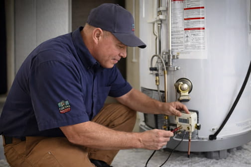 Owner Mike inspecting water heater connections in Pleasant Hill home during service call
